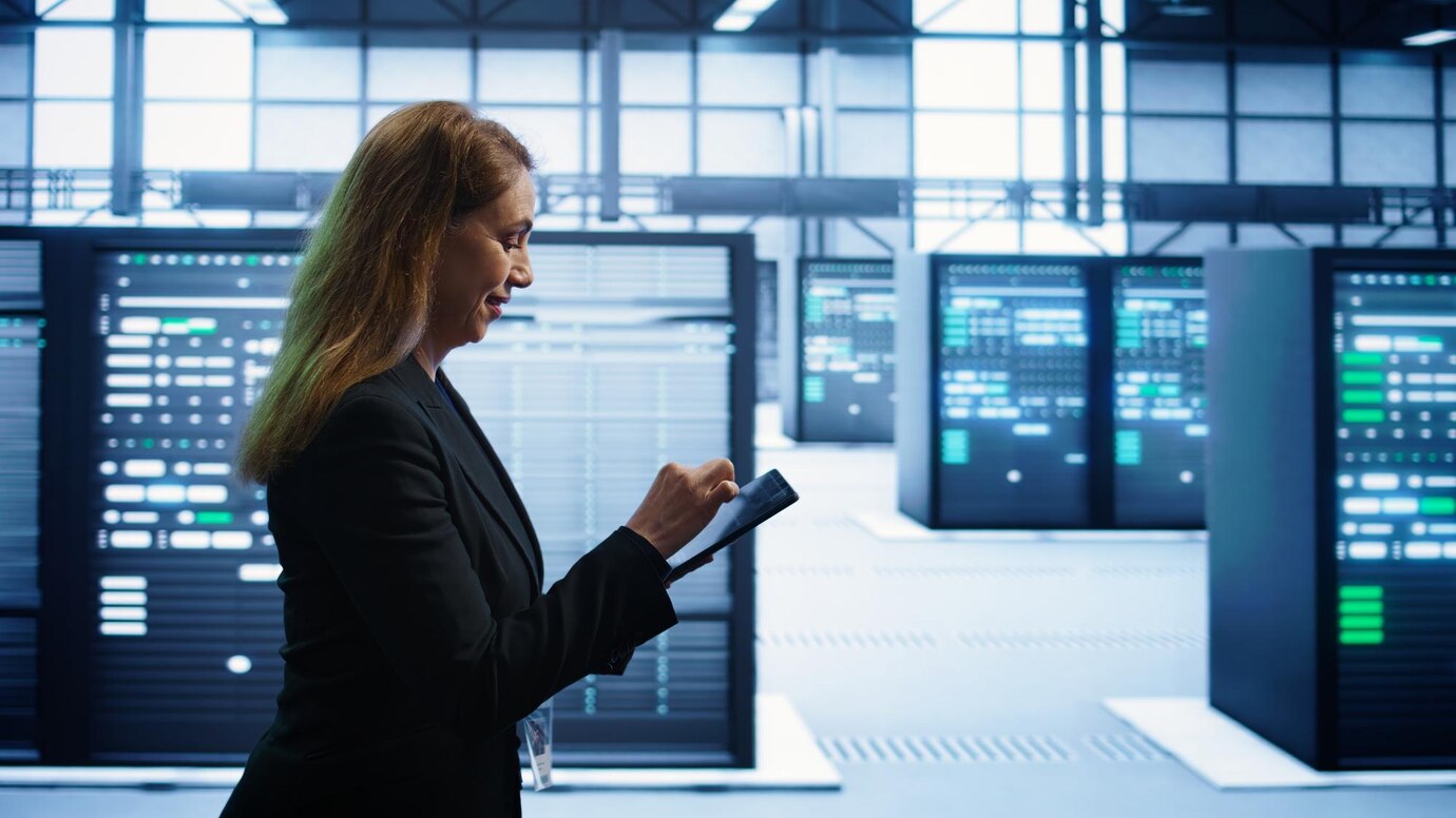 Technician inspecting data center
